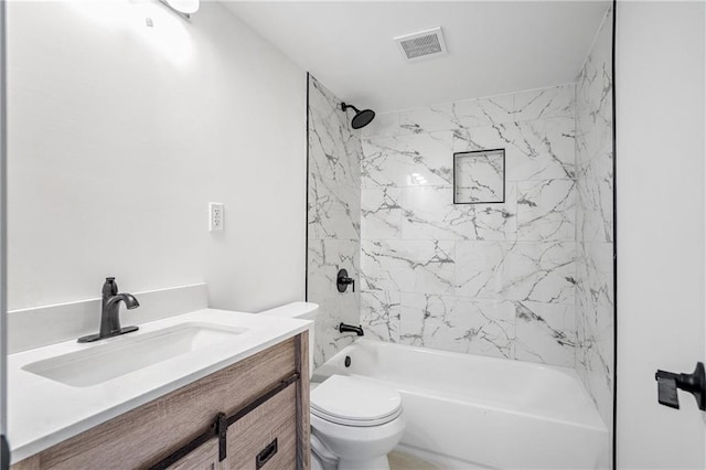 full bathroom with toilet, tiled shower / bath, and vanity