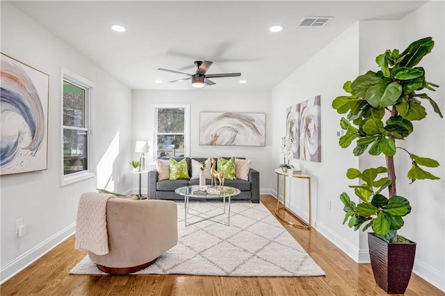 living room with ceiling fan and hardwood / wood-style floors