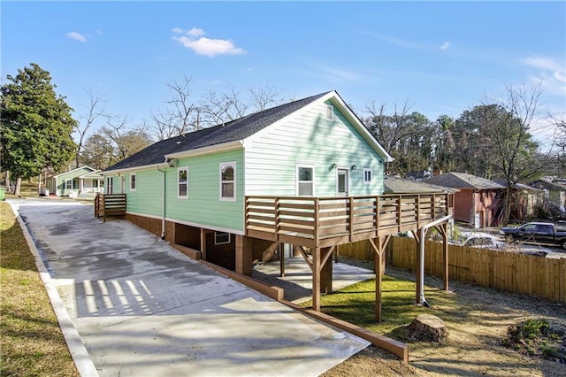 view of property exterior with a wooden deck