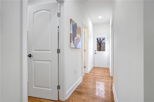 corridor with light hardwood / wood-style flooring