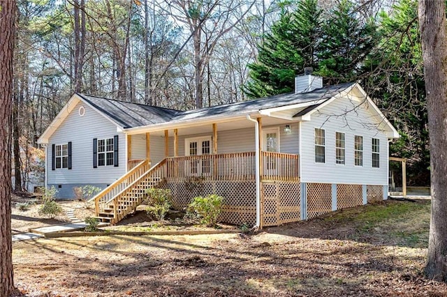 single story home featuring covered porch, crawl space, a chimney, and stairs