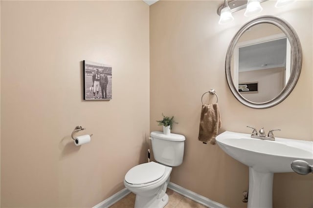 bathroom with tile patterned flooring and toilet