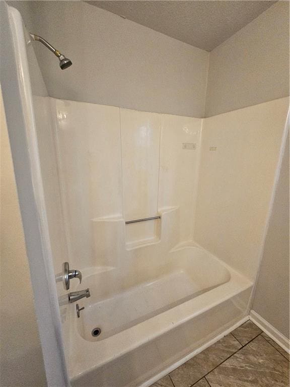 bathroom featuring bathing tub / shower combination and tile patterned floors