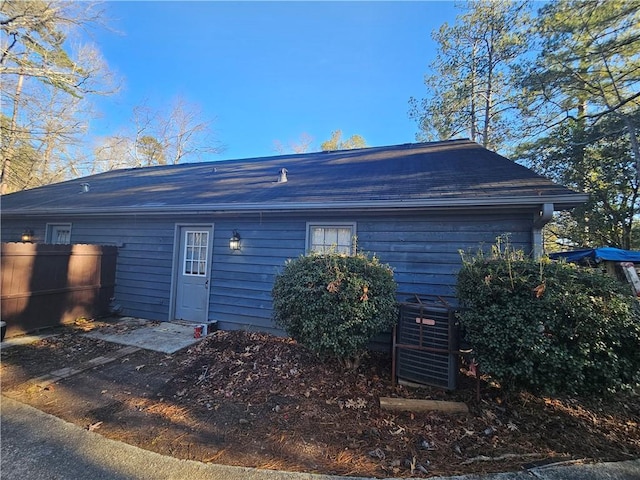 rear view of property featuring cooling unit