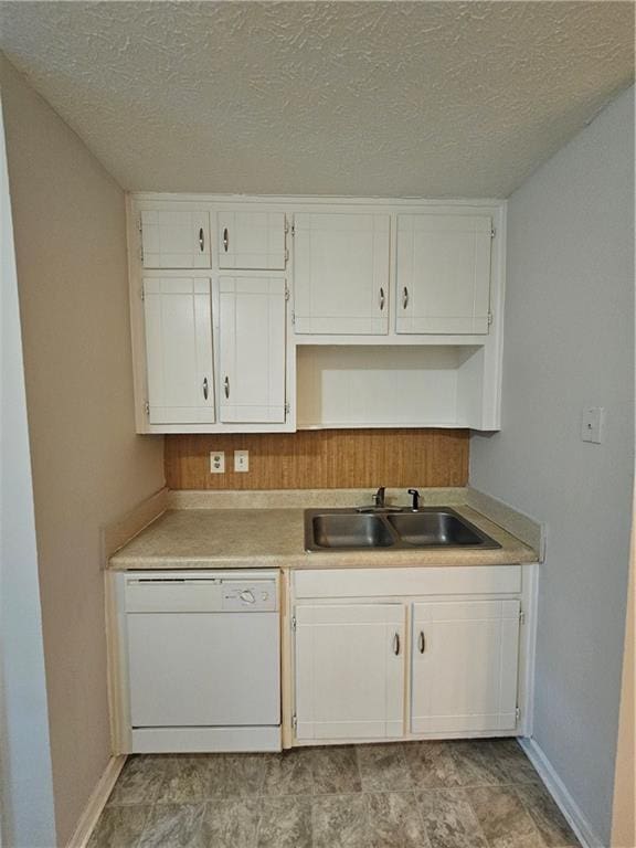 kitchen featuring white cabinetry, dishwasher, sink, and a textured ceiling