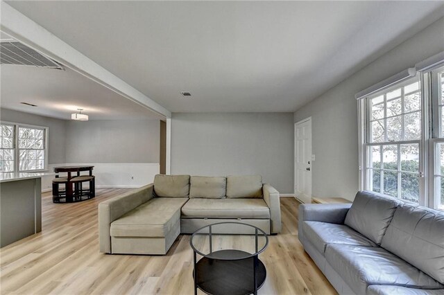 living room featuring light hardwood / wood-style floors and sink