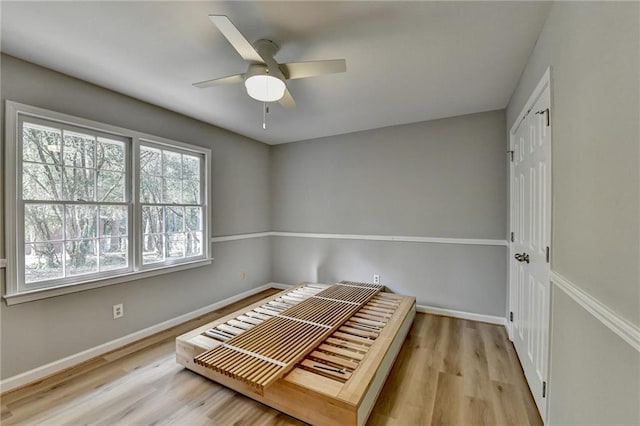 unfurnished bedroom featuring light wood-type flooring, a closet, and ceiling fan