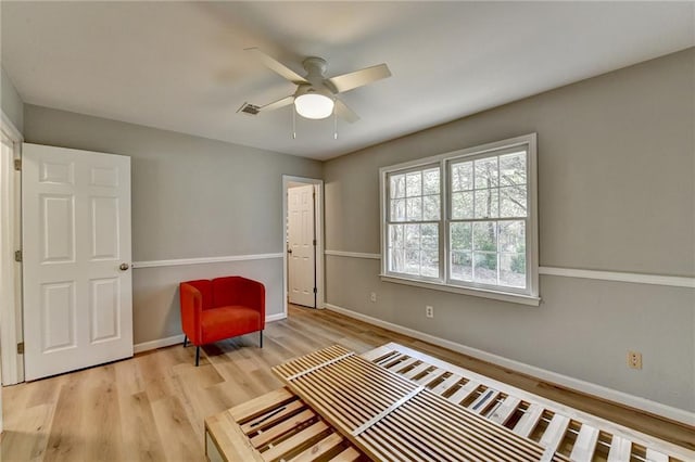 living area featuring ceiling fan and light wood-type flooring