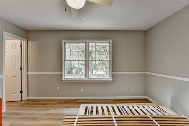 spare room featuring light hardwood / wood-style flooring and ceiling fan