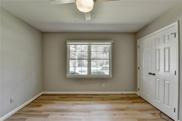 unfurnished bedroom featuring light wood-type flooring, a closet, and ceiling fan