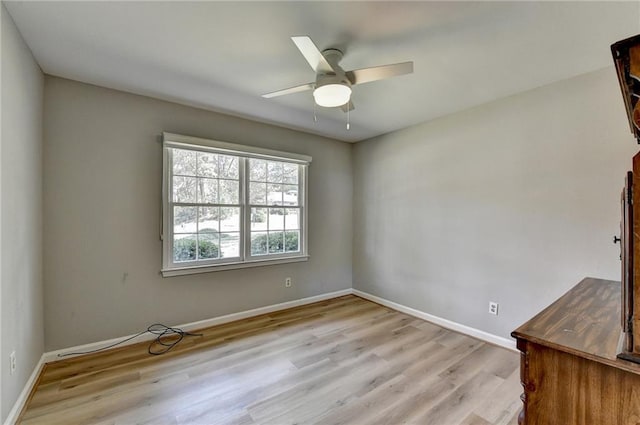 empty room featuring light wood-type flooring and ceiling fan