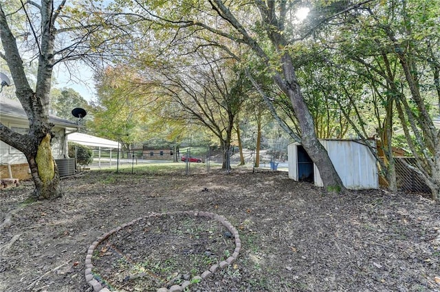 view of yard with an outbuilding and central AC