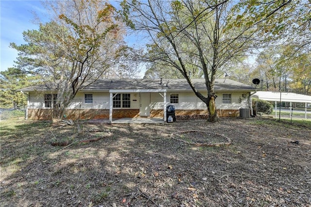 rear view of property with cooling unit