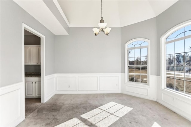 unfurnished dining area with light carpet, a chandelier, and a healthy amount of sunlight