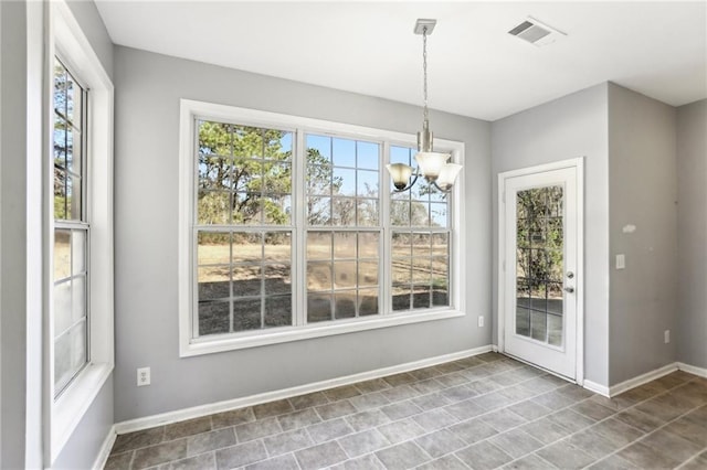 unfurnished dining area with visible vents, plenty of natural light, and baseboards