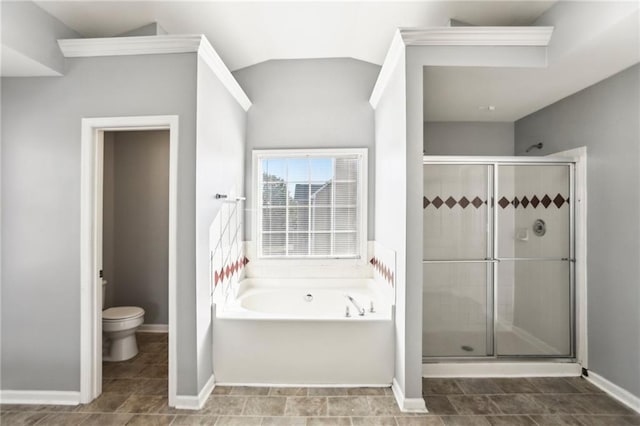 bathroom with a shower stall, toilet, lofted ceiling, and a garden tub