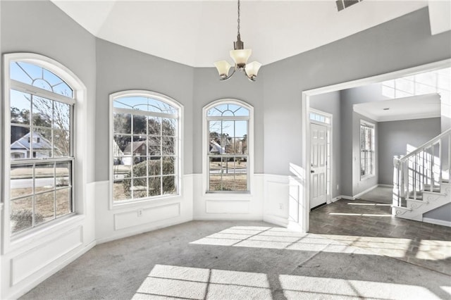 interior space with stairs, a notable chandelier, and a healthy amount of sunlight