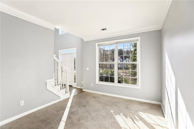 interior space featuring visible vents, crown molding, baseboards, stairway, and carpet floors