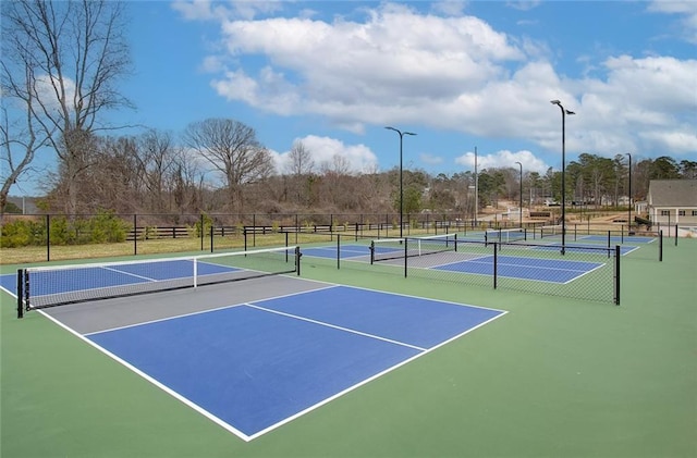 view of tennis court featuring fence