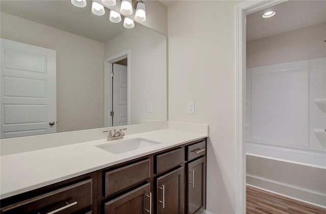 bathroom with hardwood / wood-style flooring and vanity