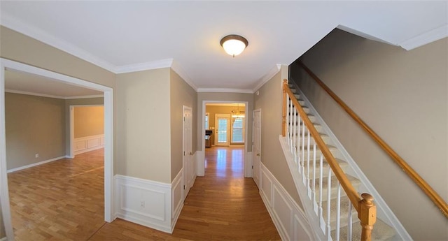 corridor with crown molding and a chandelier