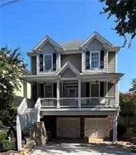 view of front facade with covered porch, an attached garage, stairs, and driveway