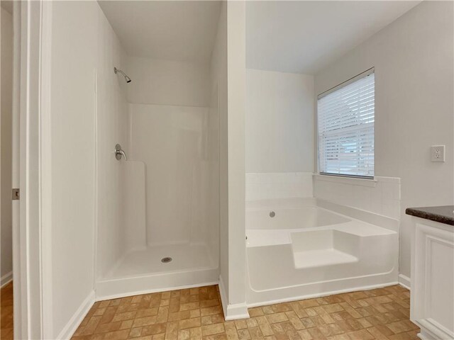 bathroom with vanity and independent shower and bath