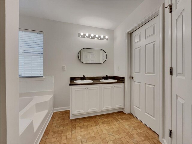 bathroom with vanity and a tub