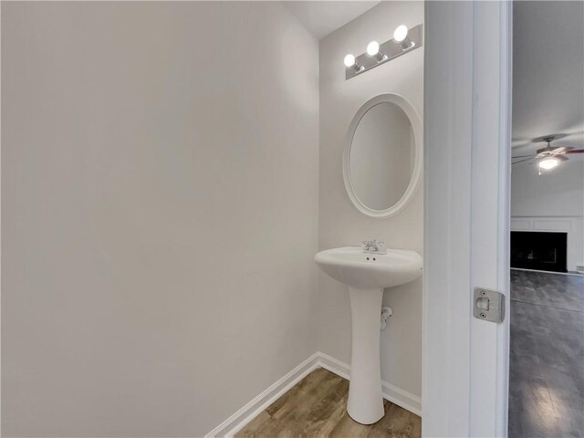 bathroom with ceiling fan and hardwood / wood-style flooring