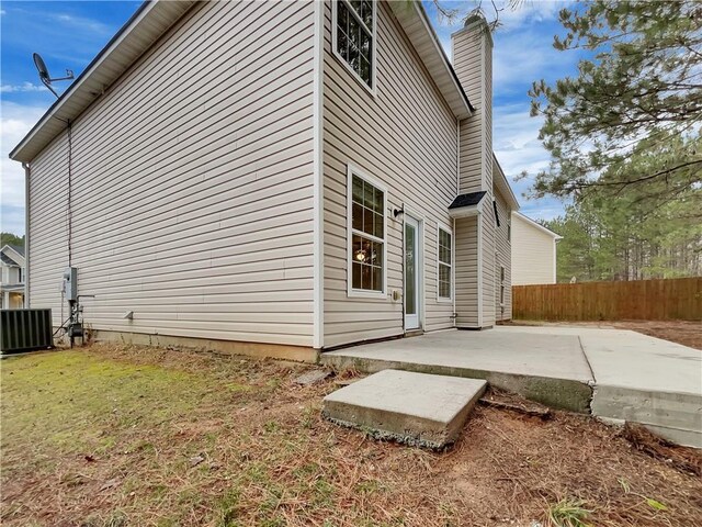 view of home's exterior with central air condition unit, a patio area, and a yard