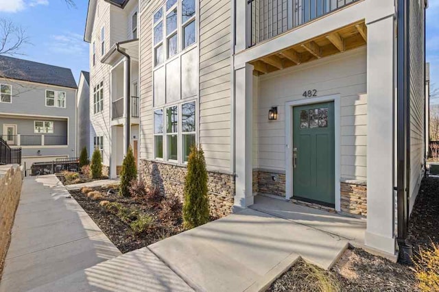 property entrance with stone siding