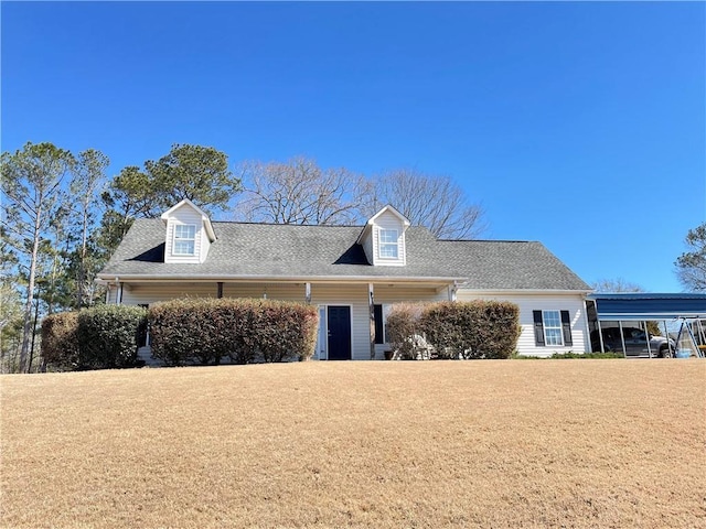 cape cod-style house featuring a carport, a front yard, and roof with shingles