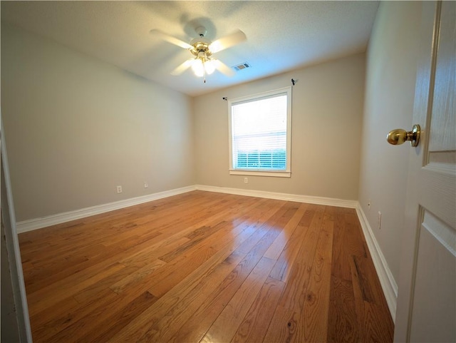 spare room with ceiling fan and light hardwood / wood-style flooring