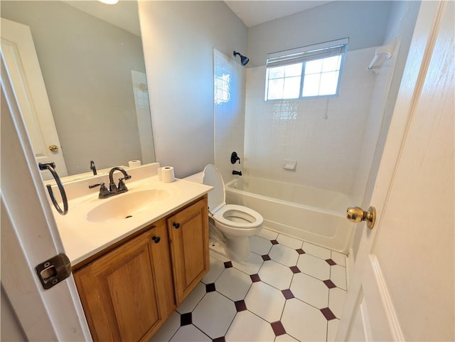 full bathroom featuring toilet, tiled shower / bath combo, and vanity