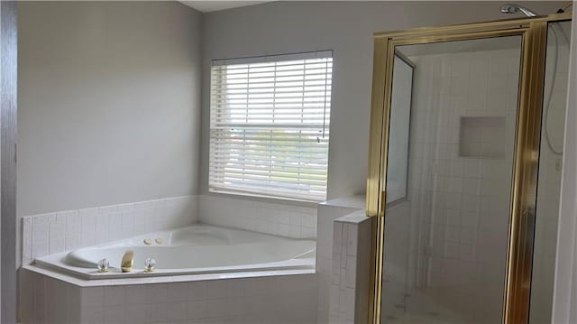 bathroom featuring separate shower and tub