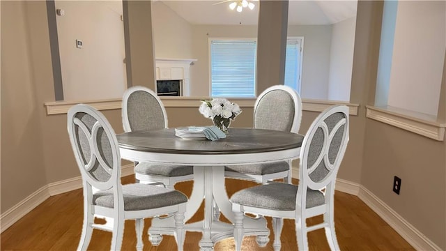 dining area featuring ceiling fan and wood-type flooring