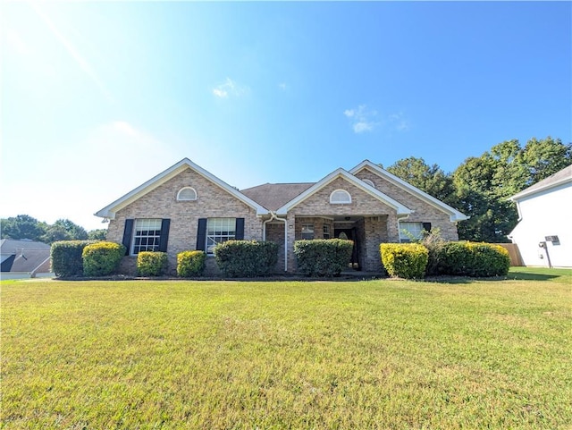 single story home featuring a front yard