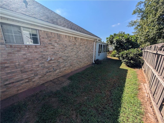 view of side of home with a lawn