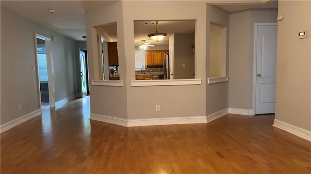 spare room featuring ceiling fan, hardwood / wood-style floors, and sink