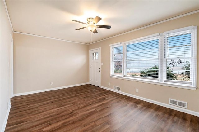 unfurnished room featuring ceiling fan, crown molding, and dark wood-type flooring