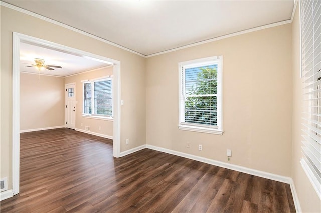 empty room with ceiling fan, dark hardwood / wood-style flooring, and ornamental molding