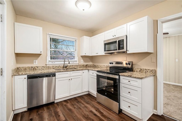 kitchen featuring dark hardwood / wood-style floors, white cabinetry, sink, and appliances with stainless steel finishes