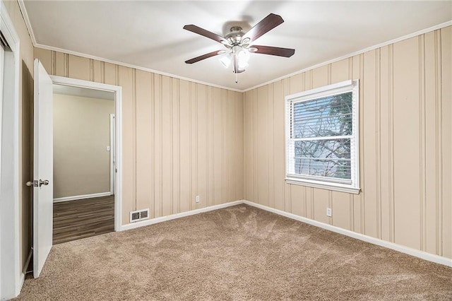 unfurnished room with carpet, ceiling fan, and ornamental molding