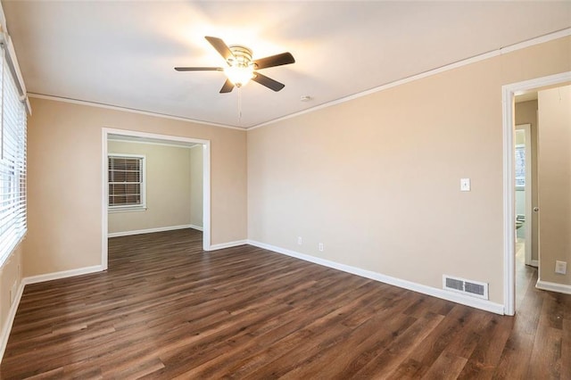 empty room with crown molding, ceiling fan, and dark hardwood / wood-style floors