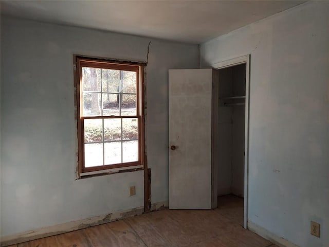 unfurnished bedroom with light hardwood / wood-style floors and a closet