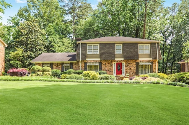 850 John Alden Rd, Stone Mountain, GA 30083 - view of front of home with a front lawn, brick siding, and a chimney