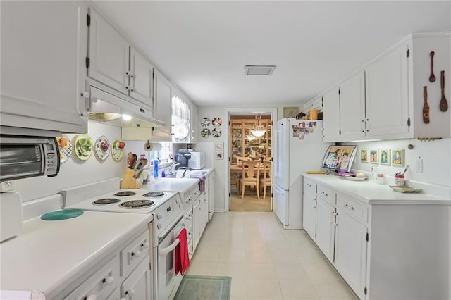 850 John Alden Rd, Stone Mountain, GA 30083 - kitchen with under cabinet range hood, white appliances, white cabinetry, and light countertops