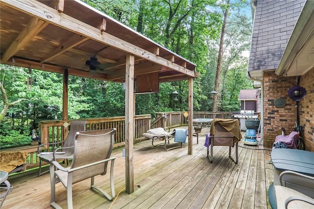 850 John Alden Rd, Stone Mountain, GA 30083 - deck featuring ceiling fan, outdoor dining area, and view of wooded area