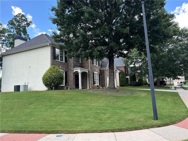 1055 Havenstone Walk, Lawrenceville, GA 30045 - view of front of house featuring a front yard and a chimney