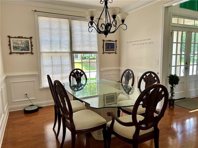 1055 Havenstone Walk, Lawrenceville, GA 30045 - dining space featuring a chandelier, a wainscoted wall, a decorative wall, crown molding, and dark wood-style flooring